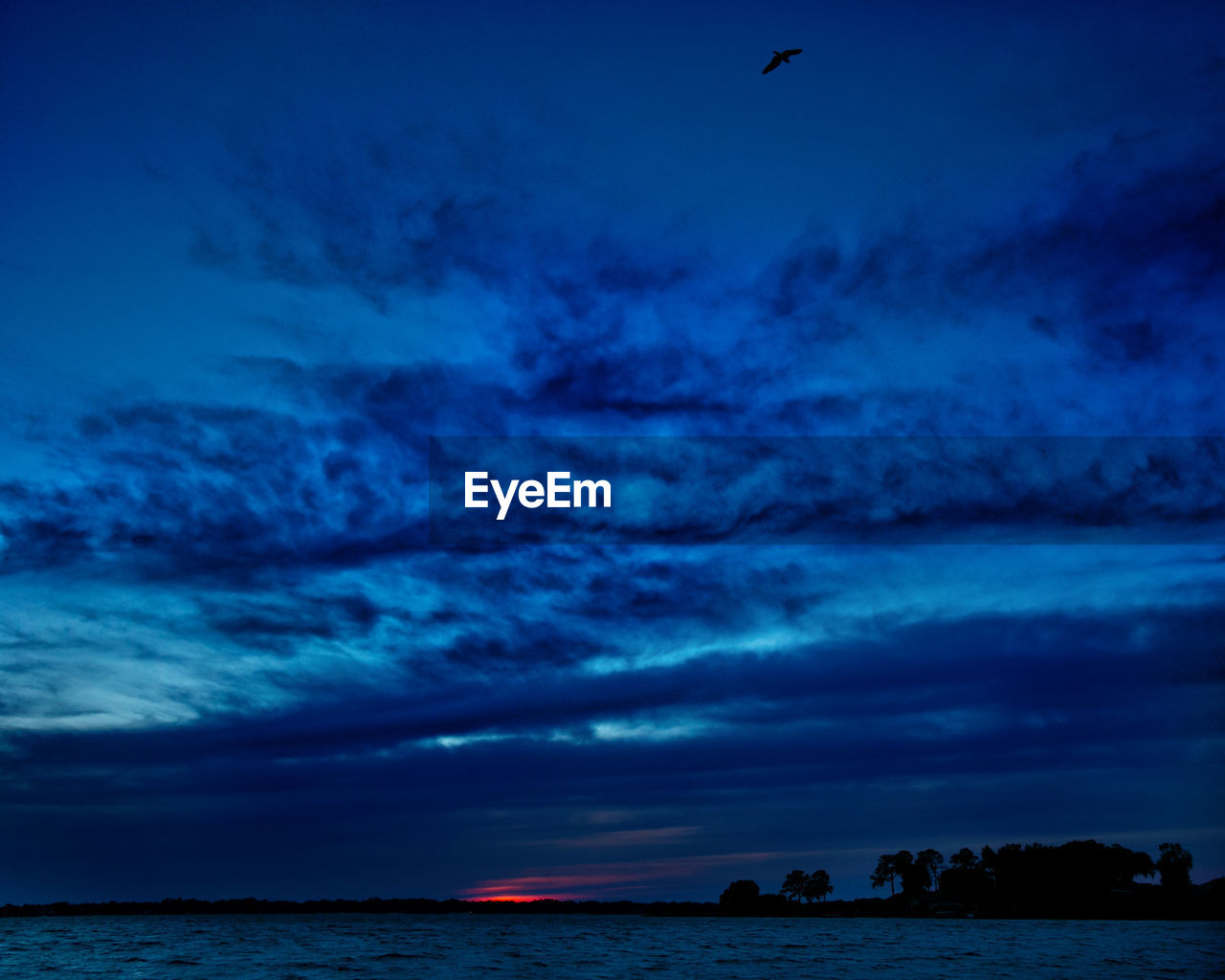 SCENIC VIEW OF SEA AT SUNSET
