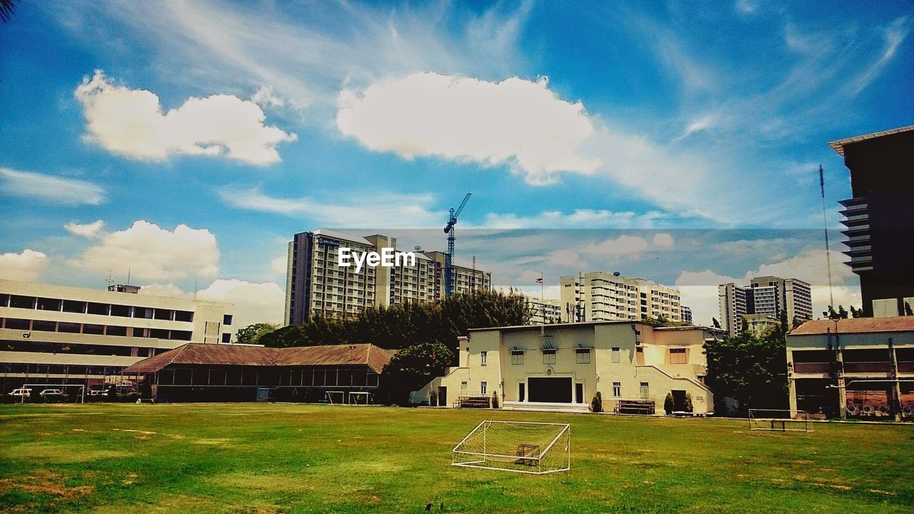 VIEW OF BUILDINGS AGAINST CLOUDY SKY