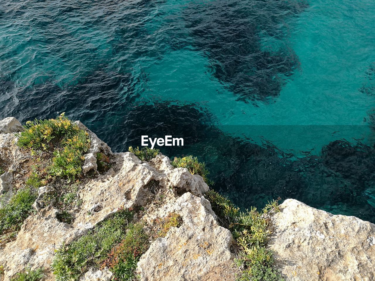 High angle view of rocks in sea