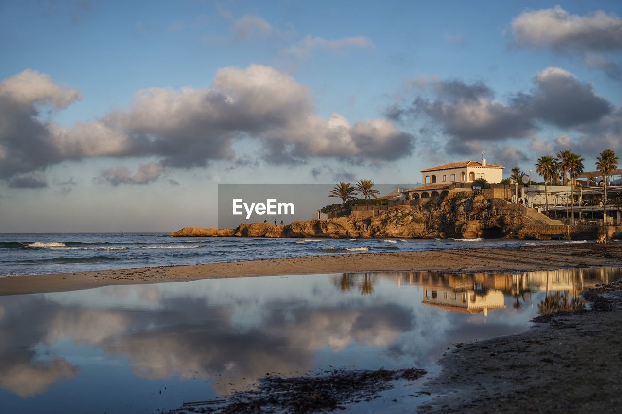 Scenic view of sea and buildings against sky