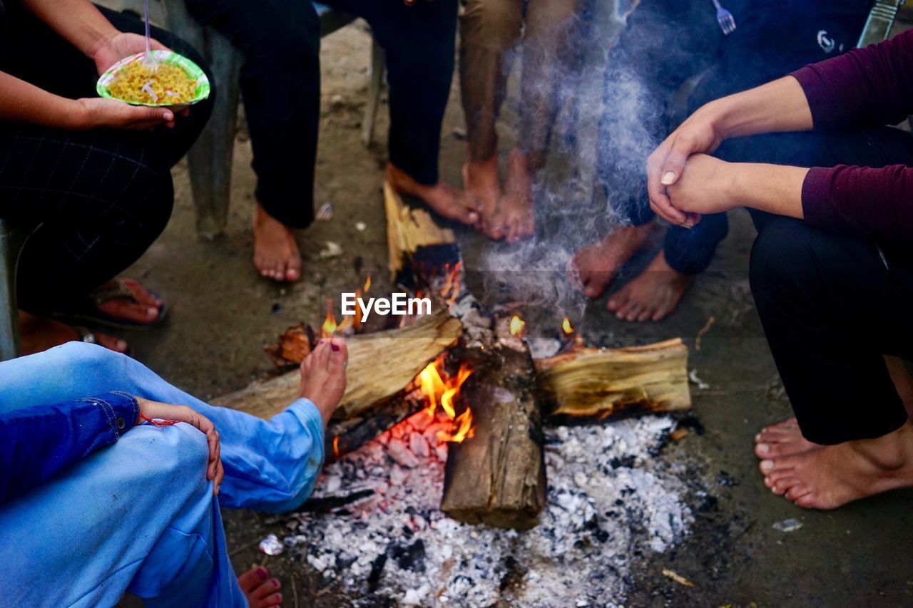 Low section of people by fire
