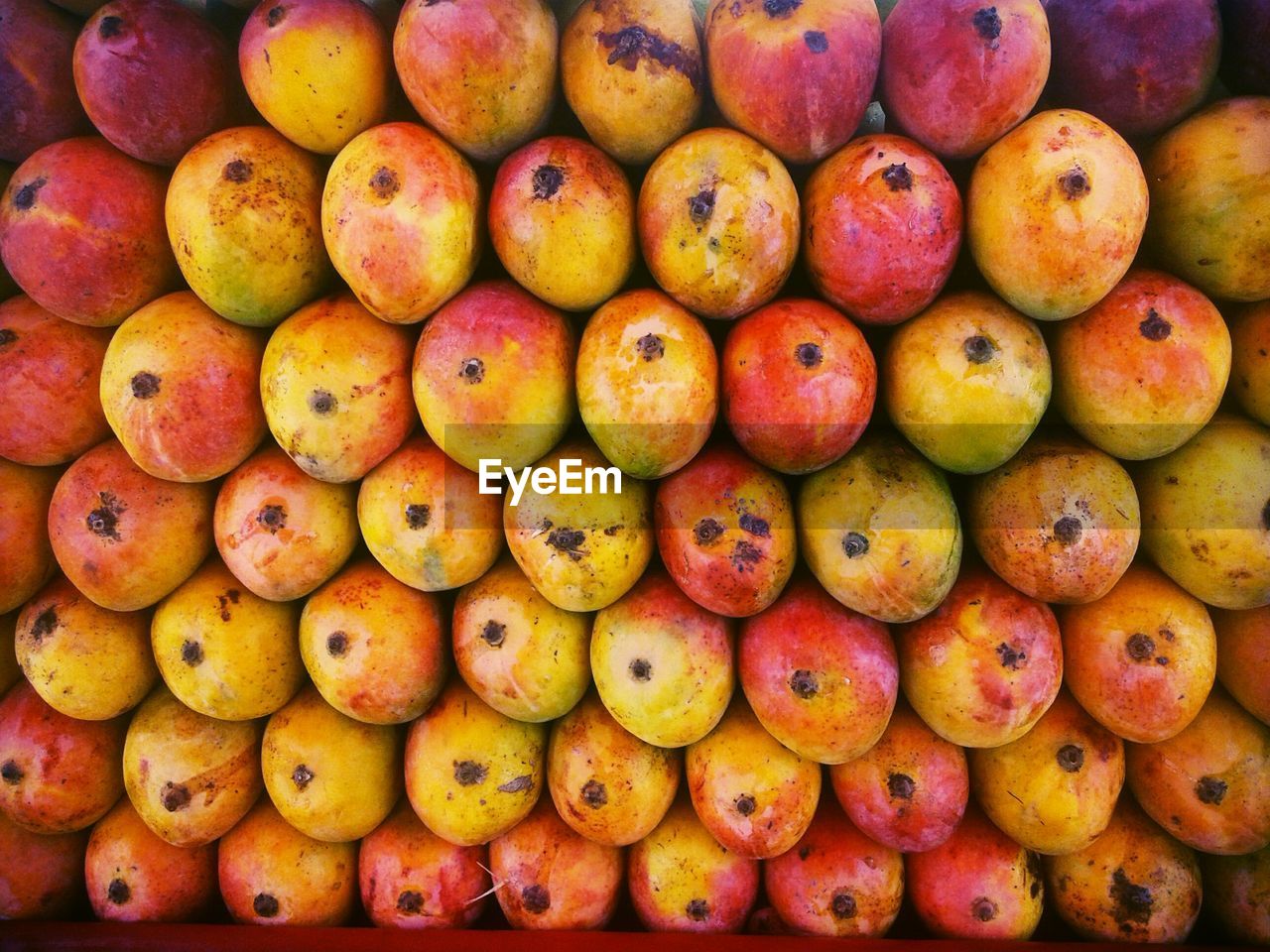 Full frame shot of stacked mangoes