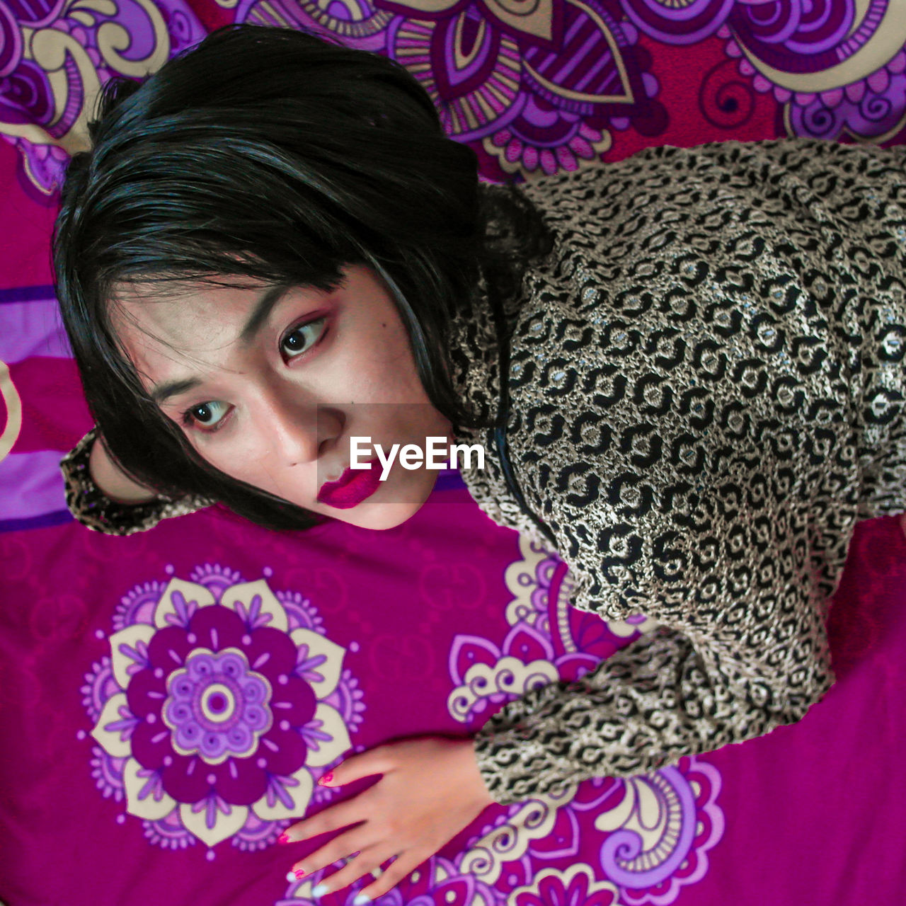 HIGH ANGLE PORTRAIT OF GIRL IN BED