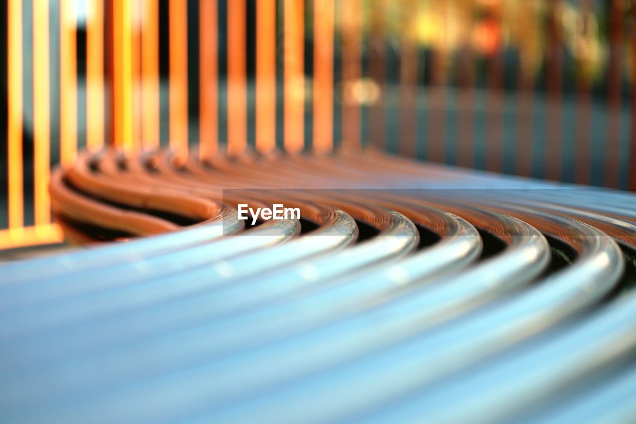 Close-up of curved metallic bench