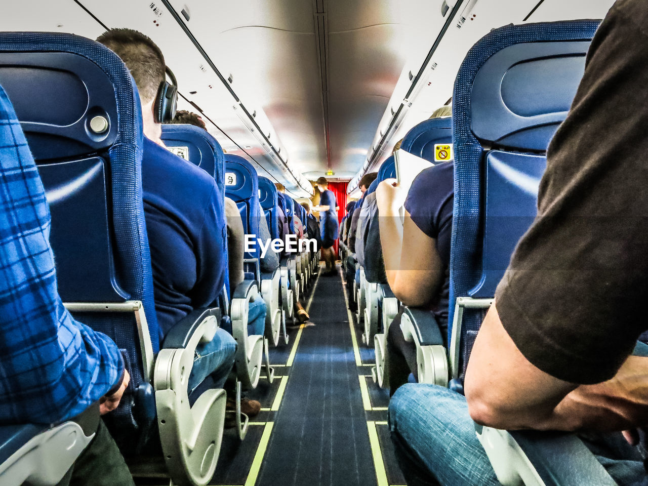 Rear view of people sitting in airplane