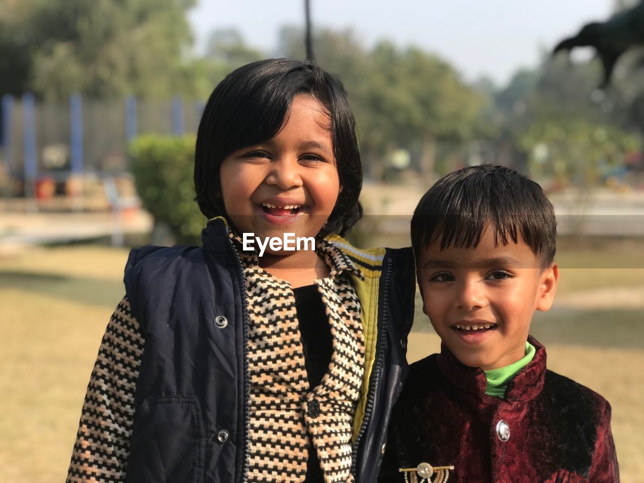 Portrait of smiling friends at public park