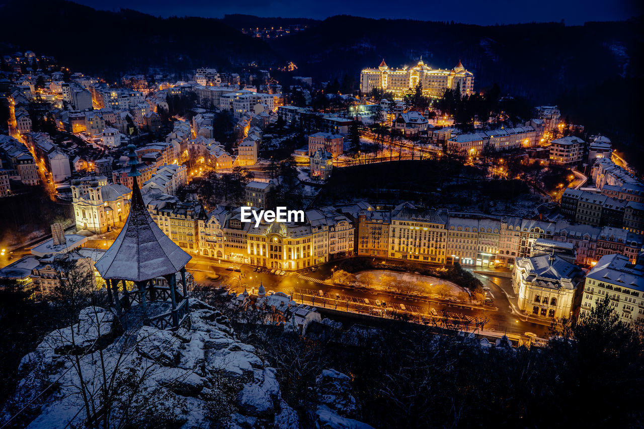 High angle view of illuminated buildings in city at night