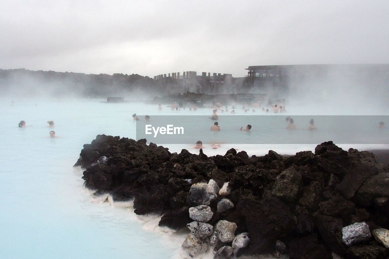 Group of people bathe in the blue lagoon