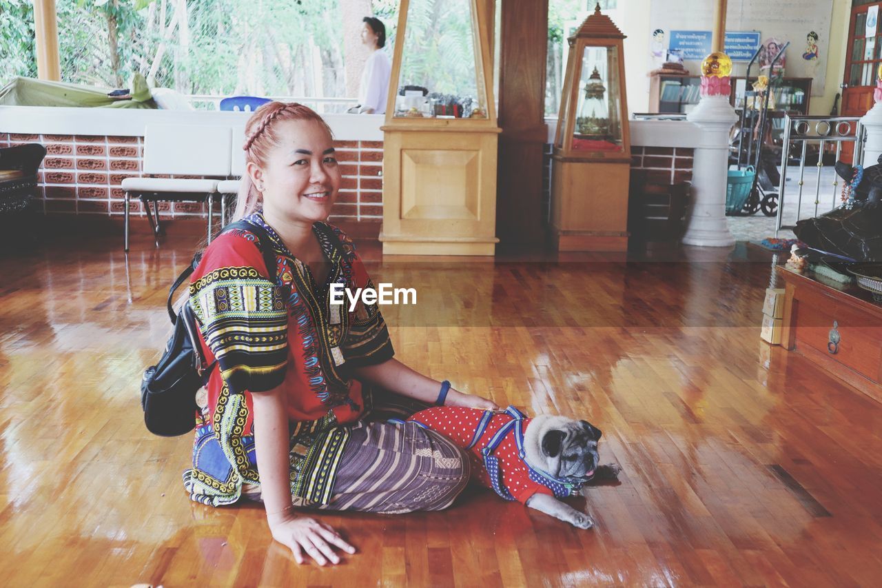 BOY SITTING ON HARDWOOD FLOOR