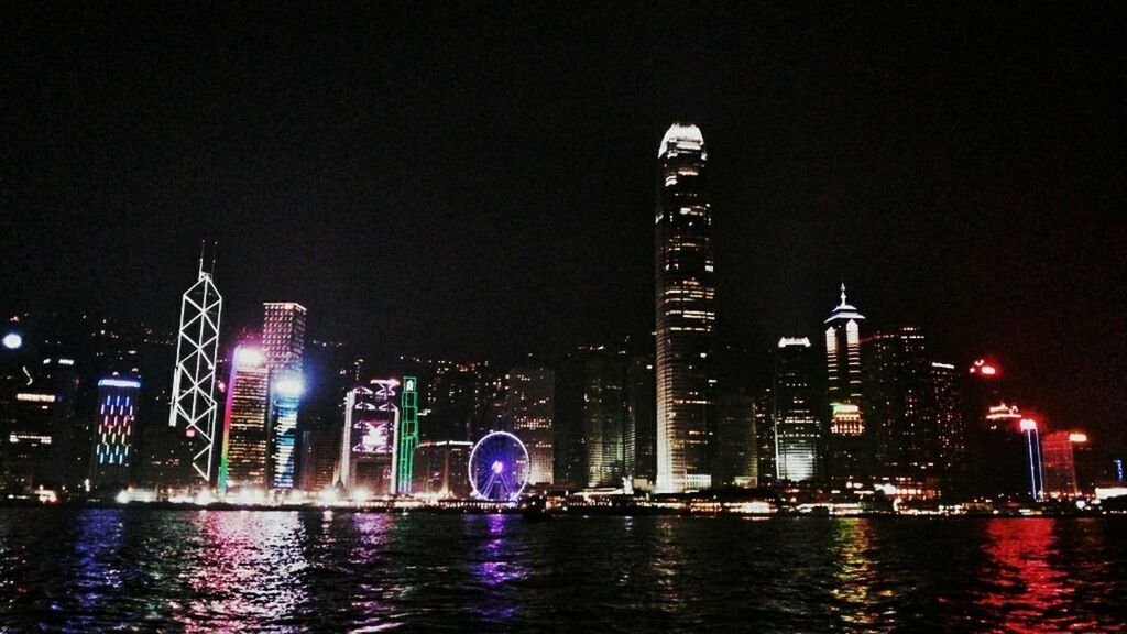 VIEW OF ILLUMINATED CITY AT NIGHT