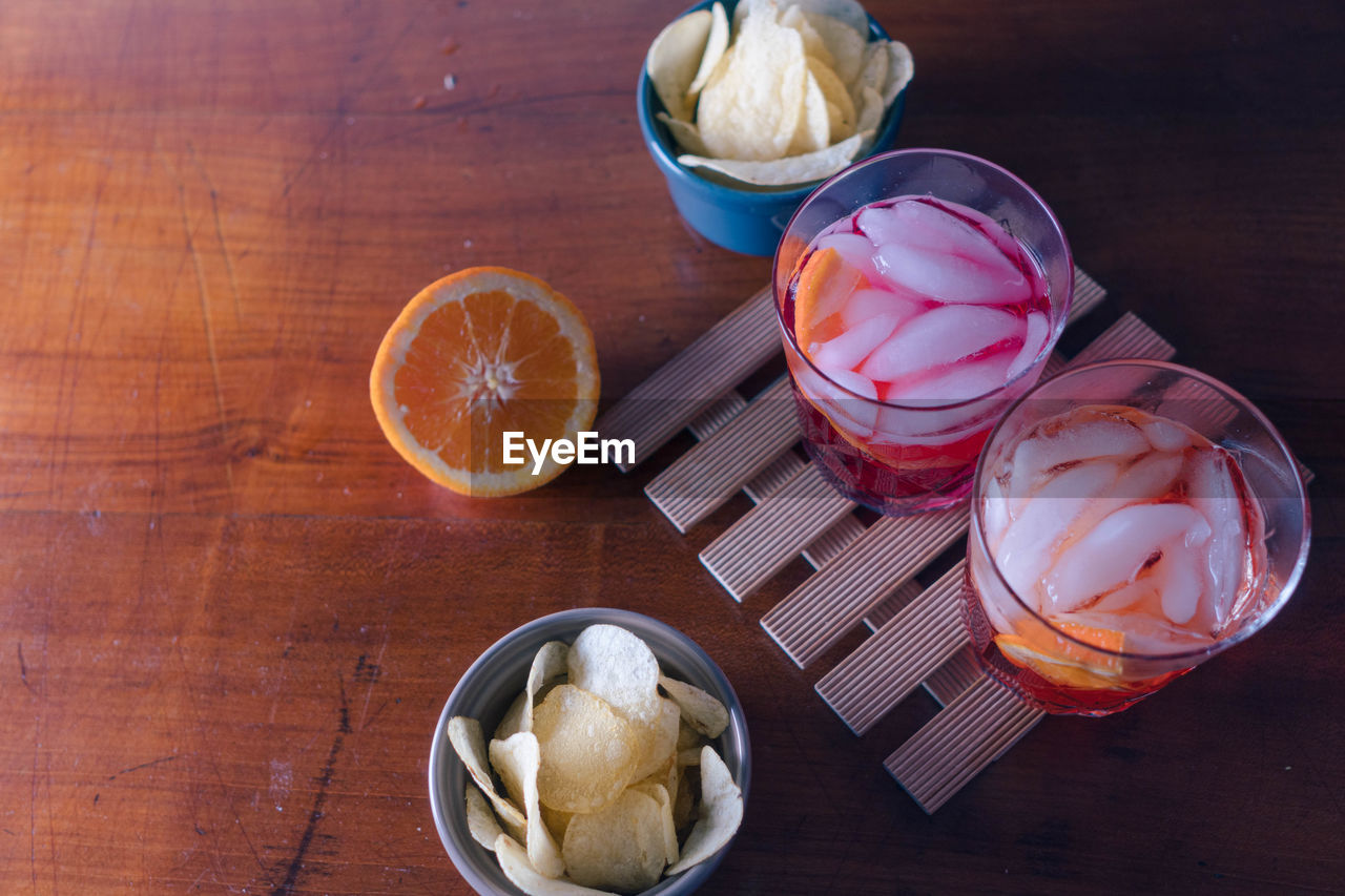 Two spritz with some chips on the table ready for the aperitif