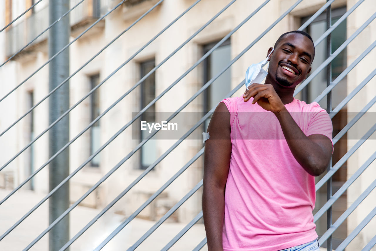 Young black man vaccinated showing his arm