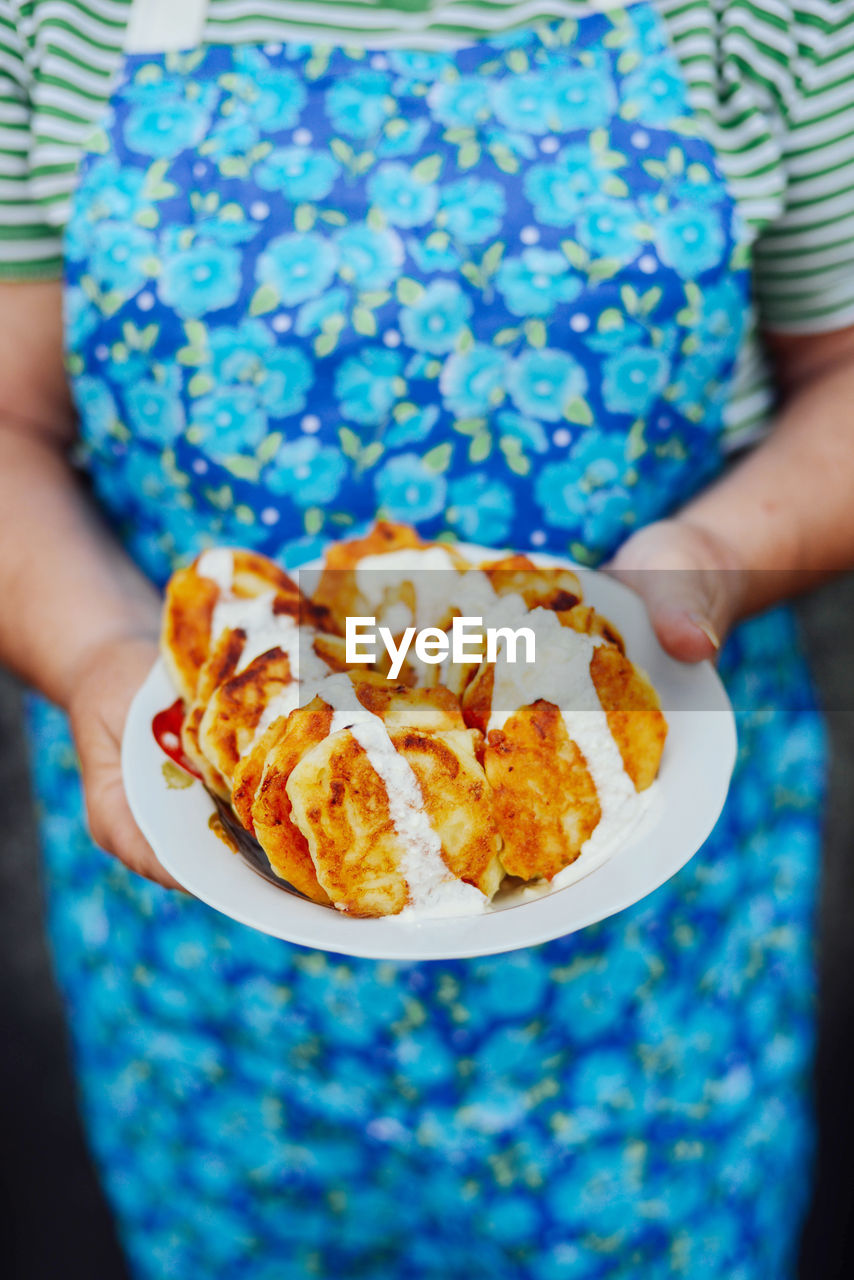 Midsection of woman holding dessert