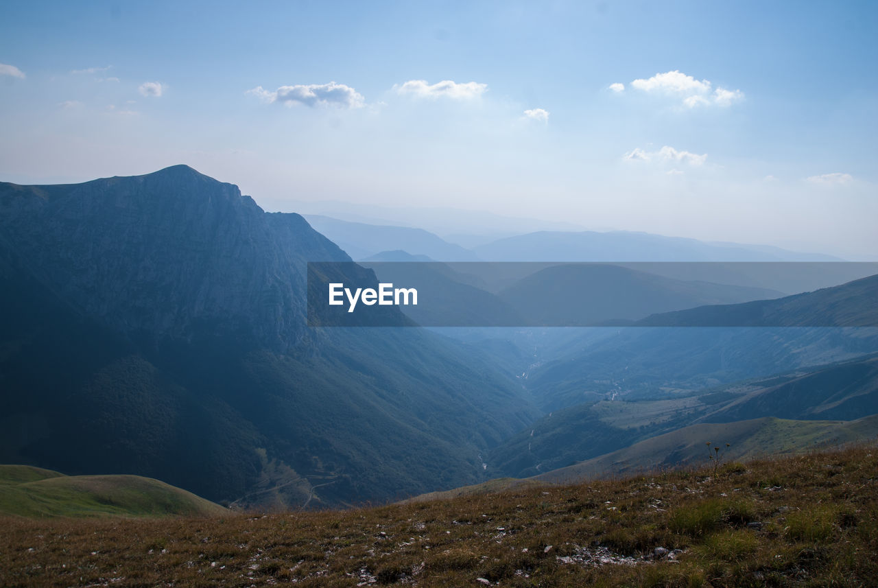 Scenic view of mountains against sky during foggy weather