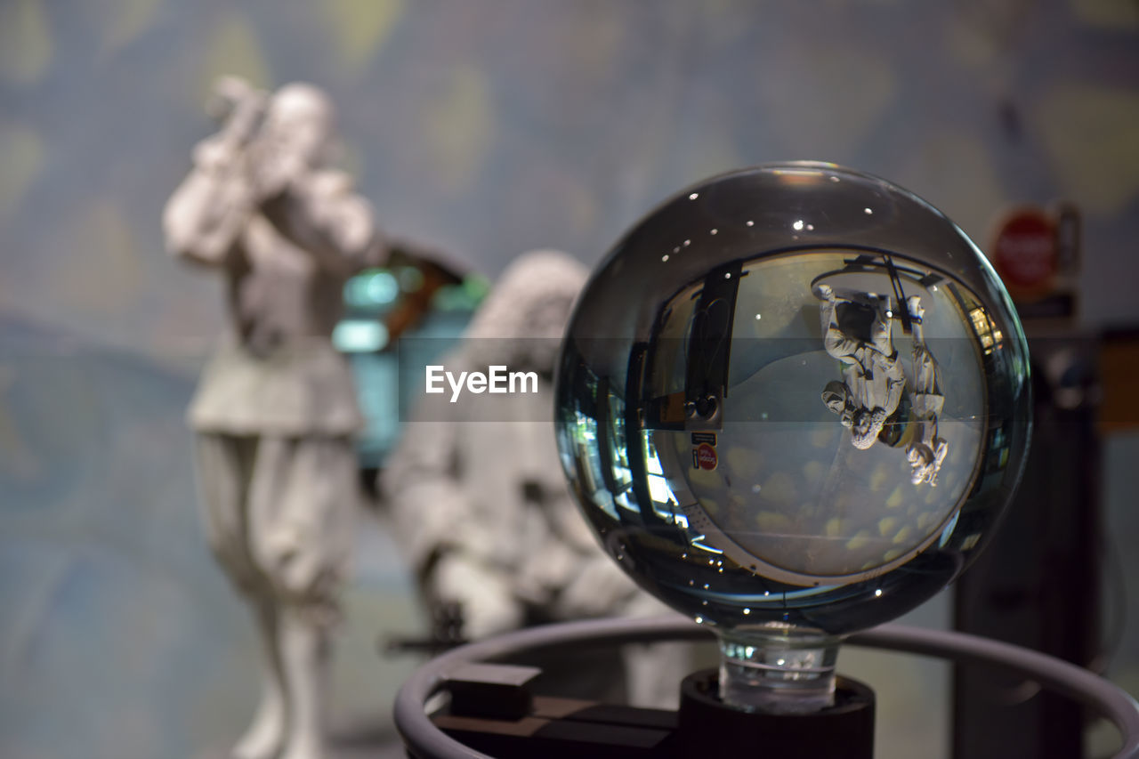 CLOSE-UP OF REFLECTION OF CRYSTAL BALL ON GLASS