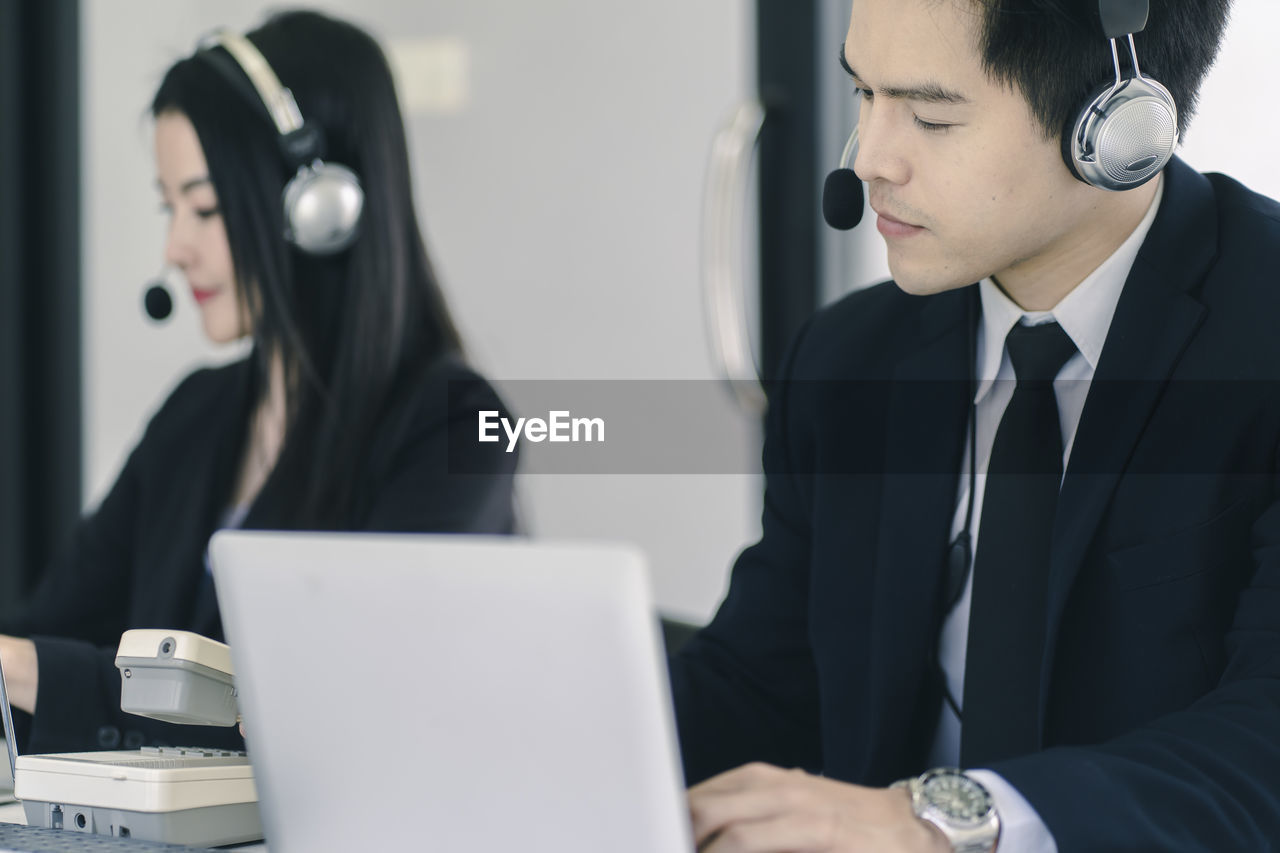 Close-up of businessman working at desk in office