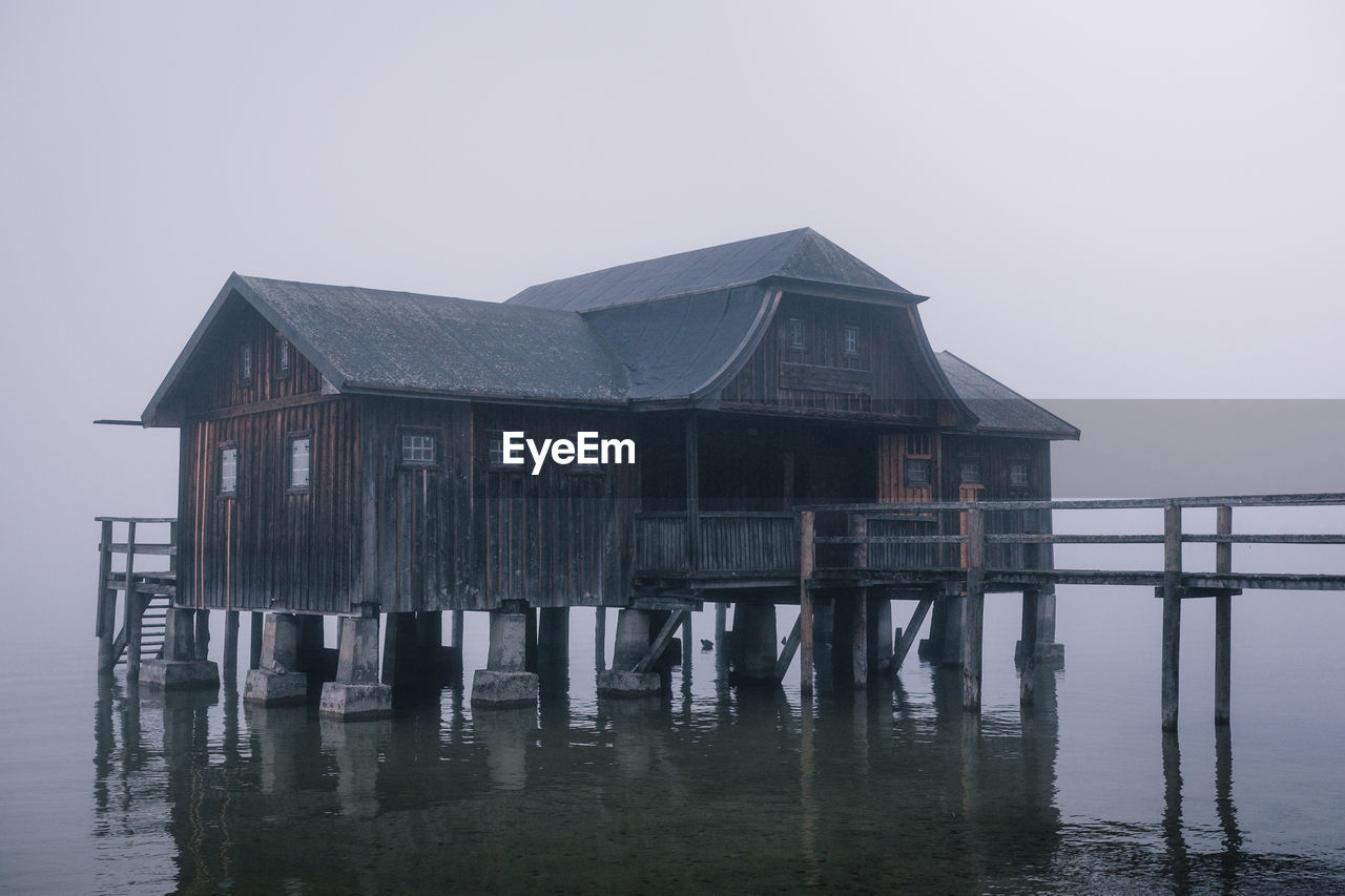 House by sea against clear sky