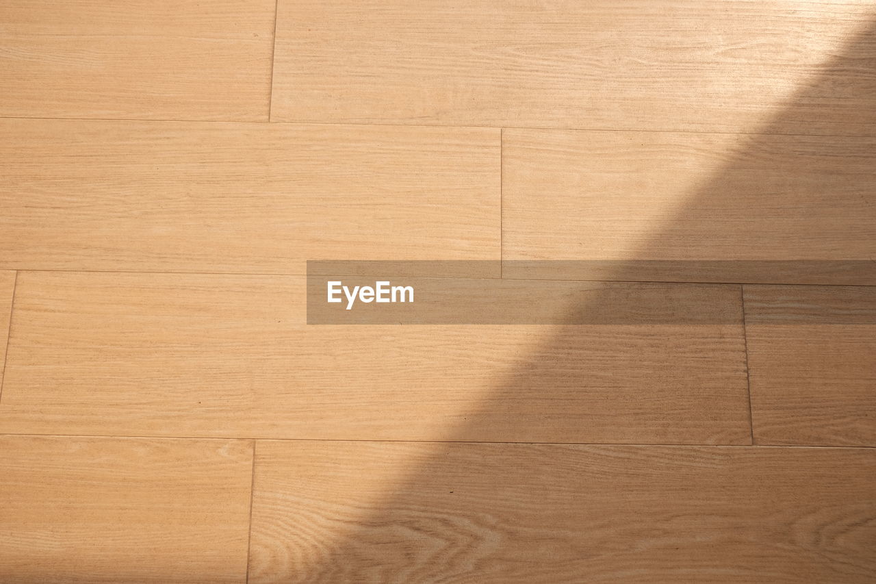 HIGH ANGLE VIEW OF SHADOW OF HARDWOOD FLOOR