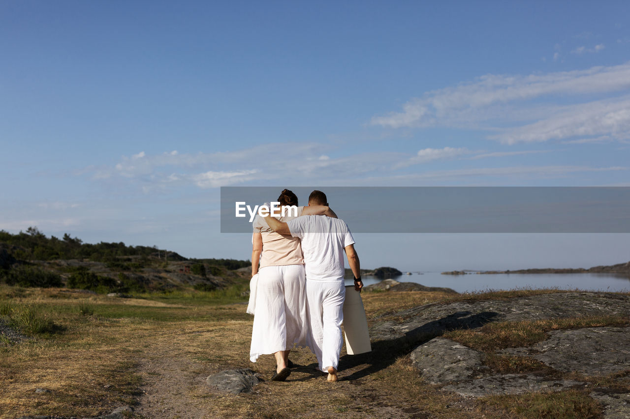 Rear view of couple walking together
