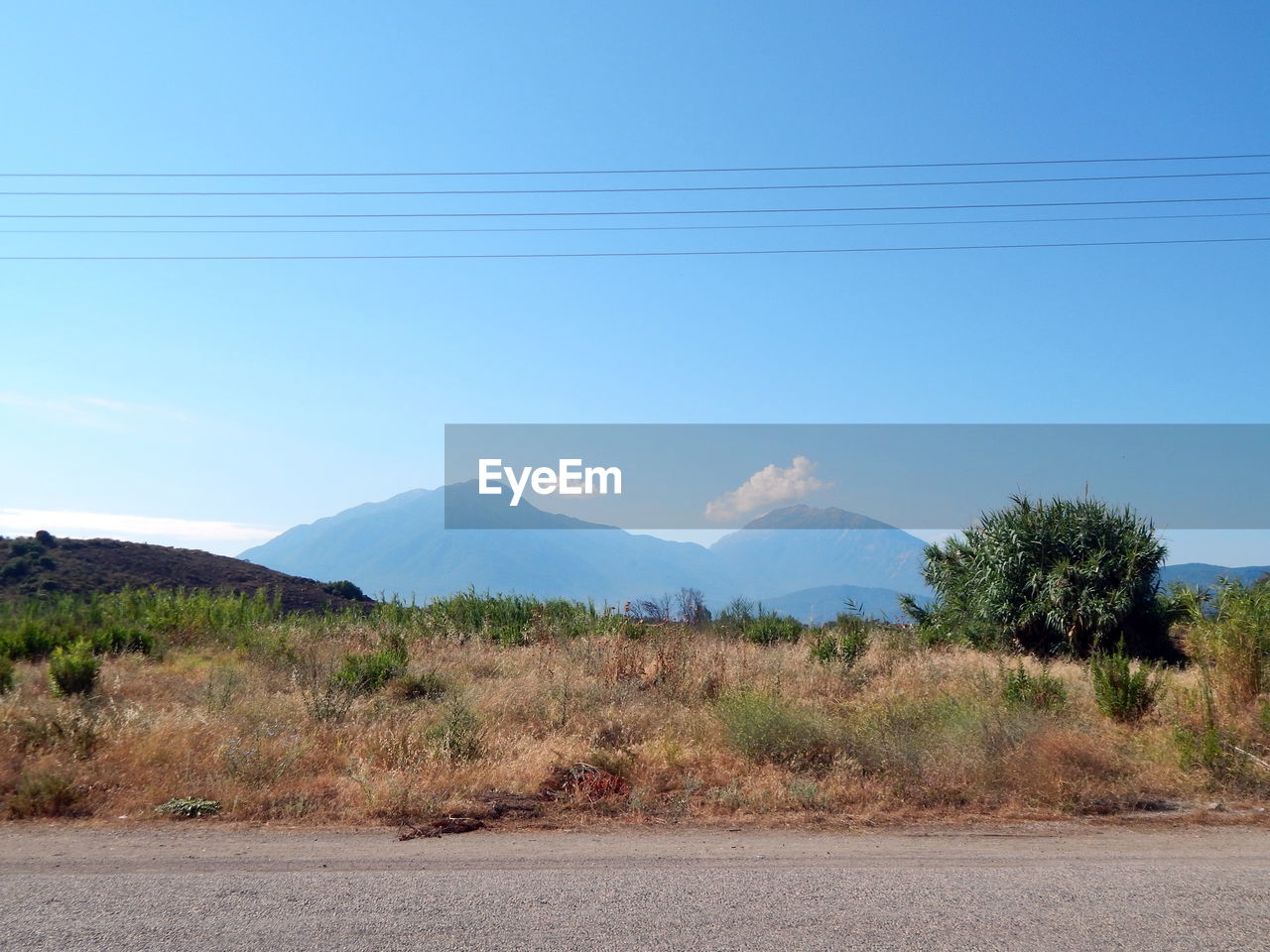 Scenic view of mountains against clear blue sky