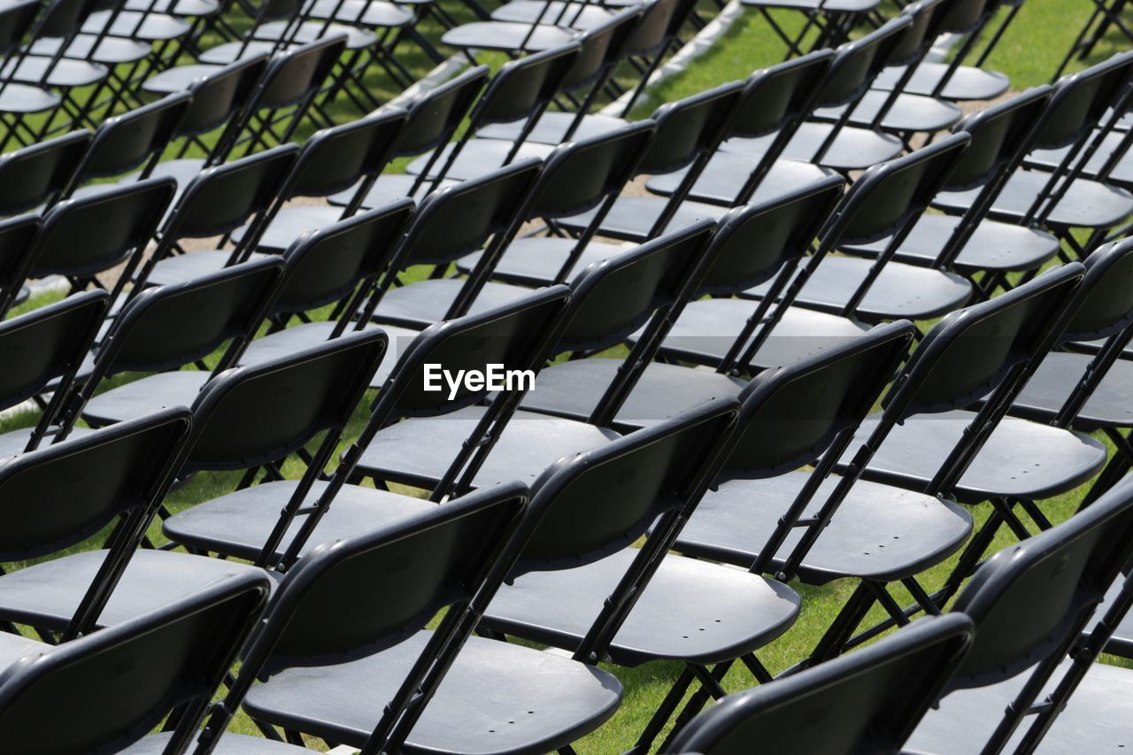 Full frame shot of empty chairs arranged on field