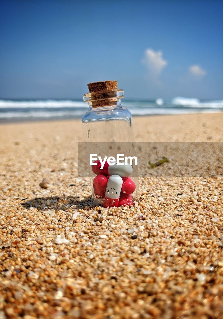 land, beach, sand, sea, sky, water, nature, shore, holiday, day, vacation, horizon over water, coast, trip, horizon, summer, selective focus, beauty in nature, tranquility, outdoors, no people, container, cloud, sunlight, scenics - nature, tranquil scene, pebble