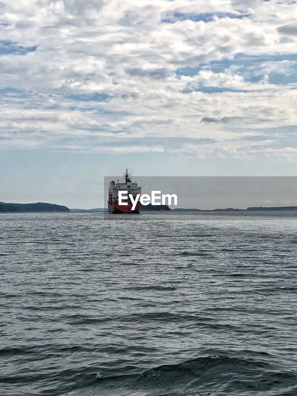 NAUTICAL VESSEL SAILING IN SEA AGAINST SKY