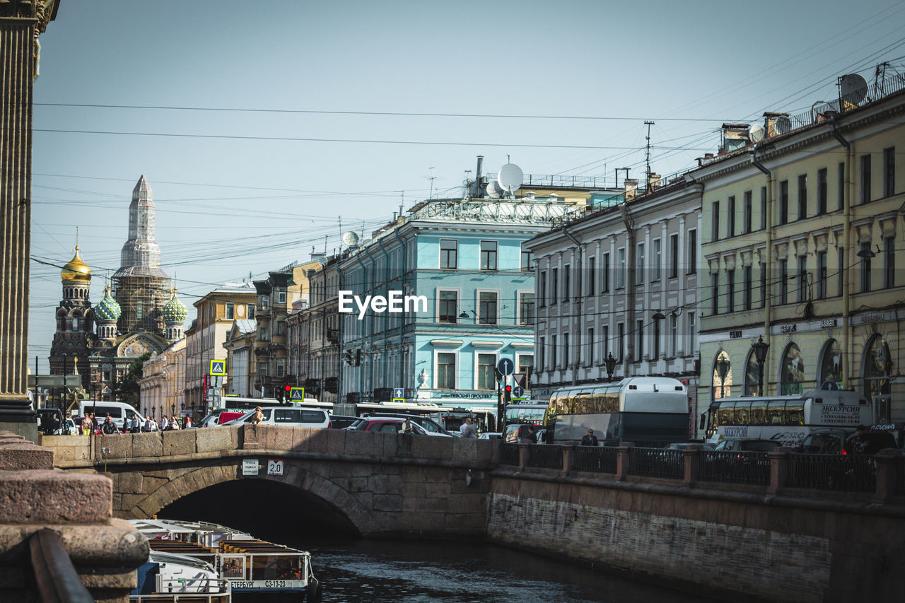 Bridge over river against buildings in city. saint petersburg, russia.
