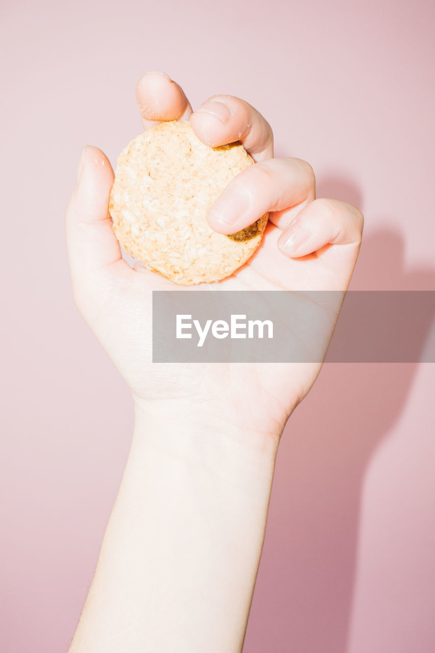 Close-up of hand holding cookie