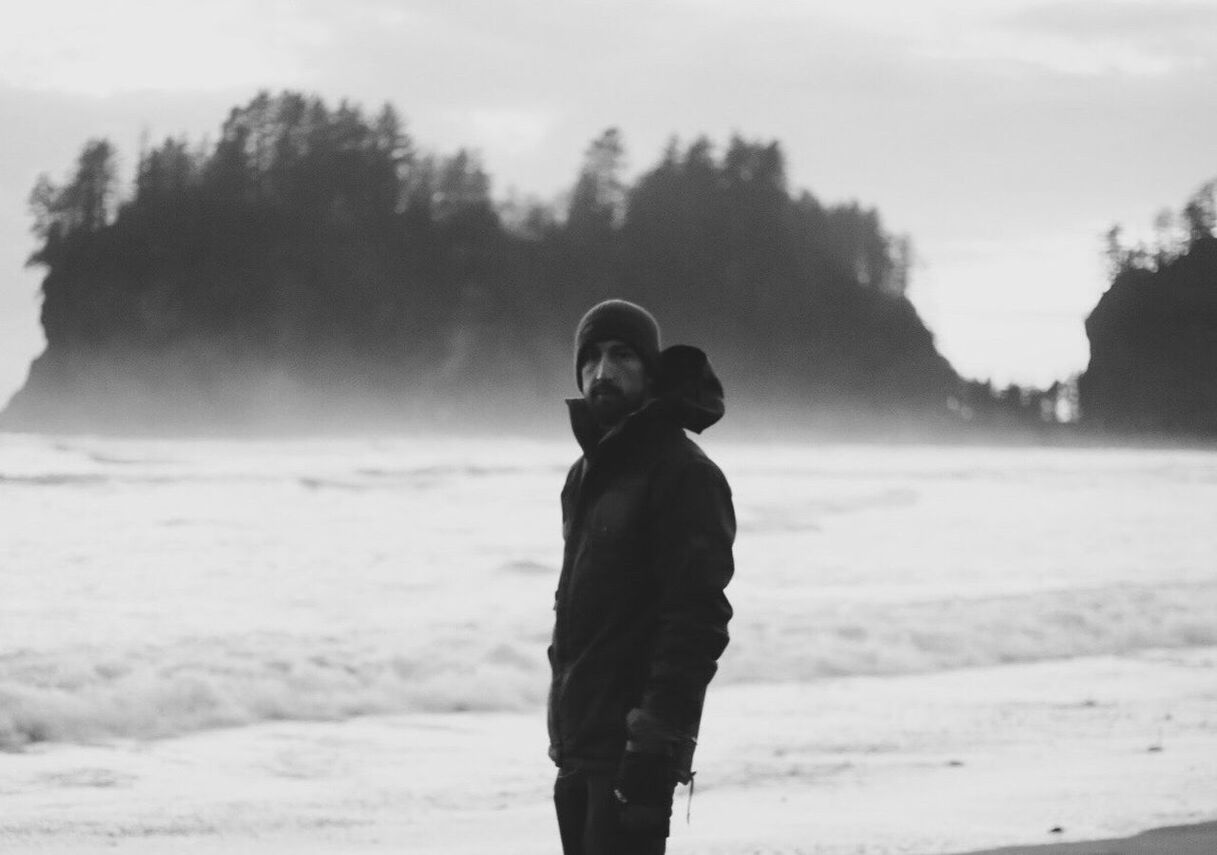 FULL LENGTH OF MAN STANDING ON SNOW COVERED LANDSCAPE