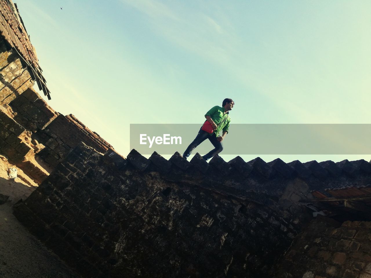 Tourist walking on steps of fort against sky