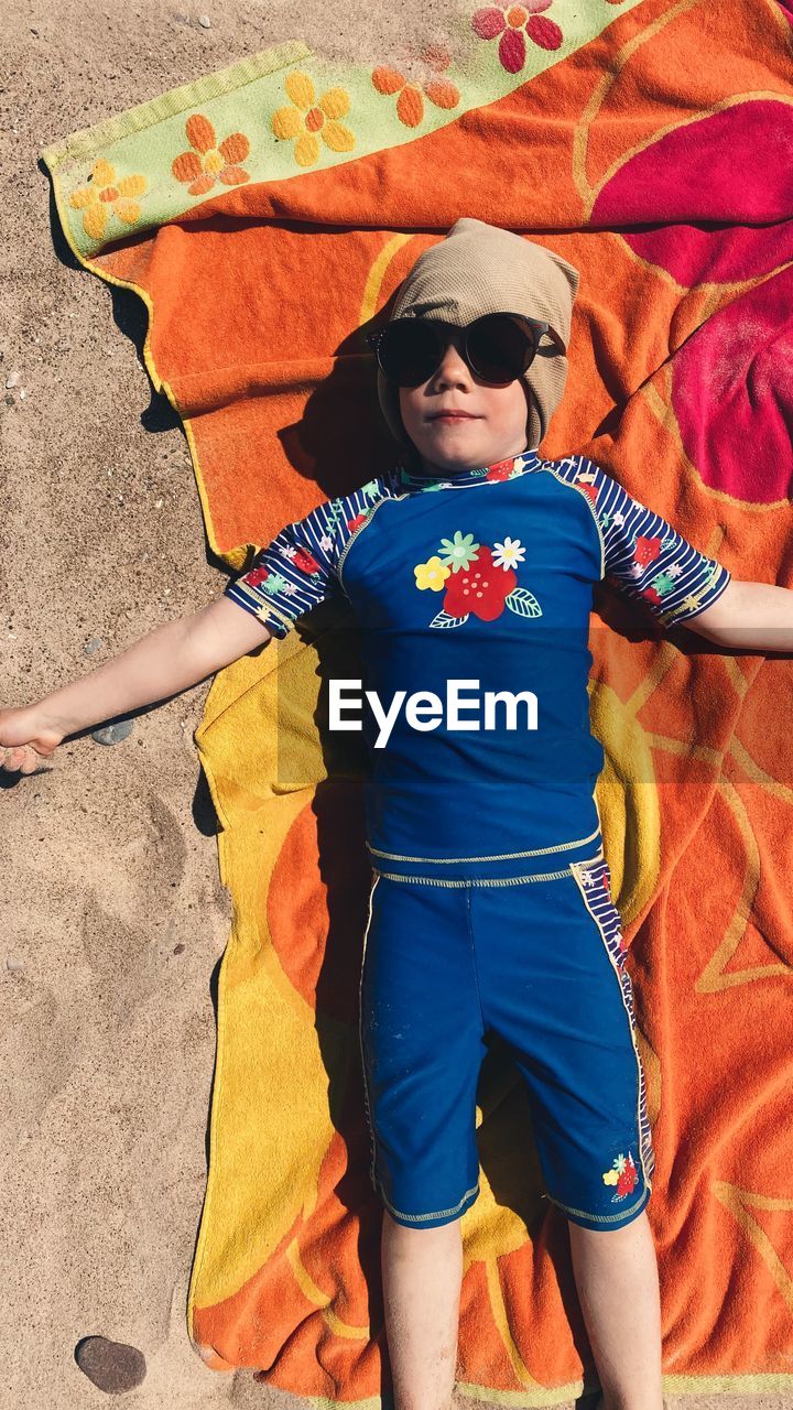 High angle view of girl lying on beach