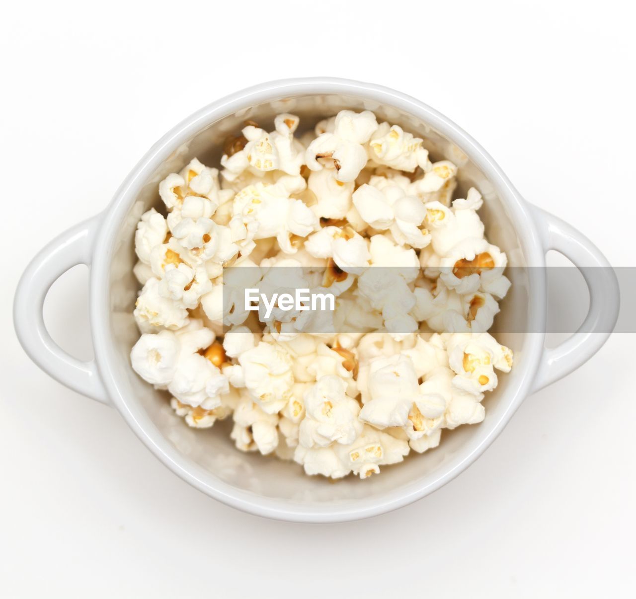 Close-up of popcorn in bowl over white background