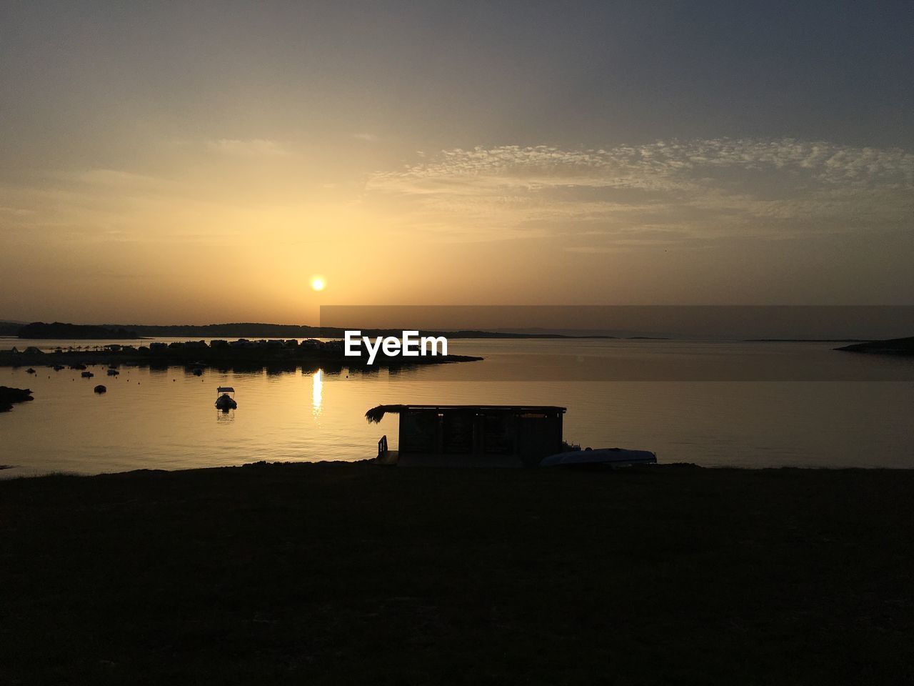 Scenic view of lake against sky during sunset