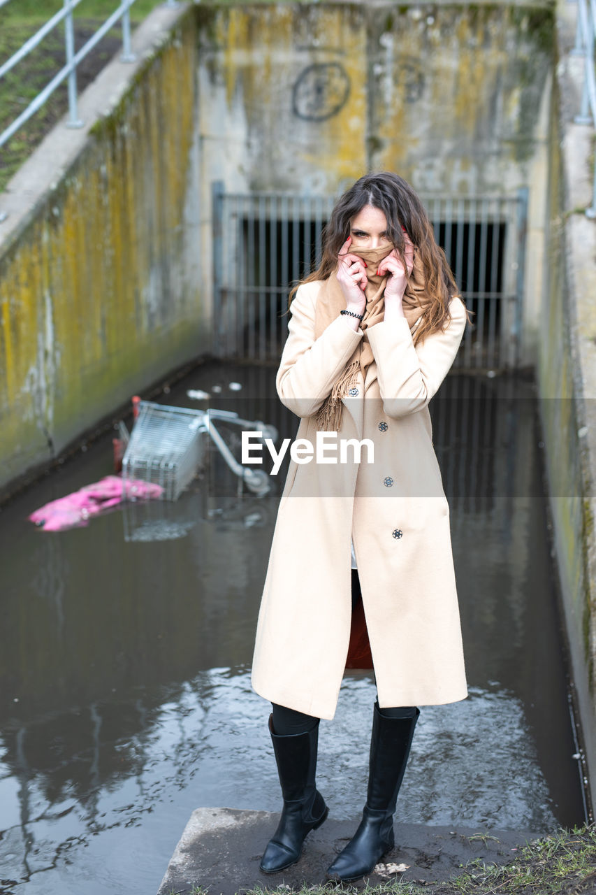 WOMAN HOLDING UMBRELLA STANDING IN WINTER