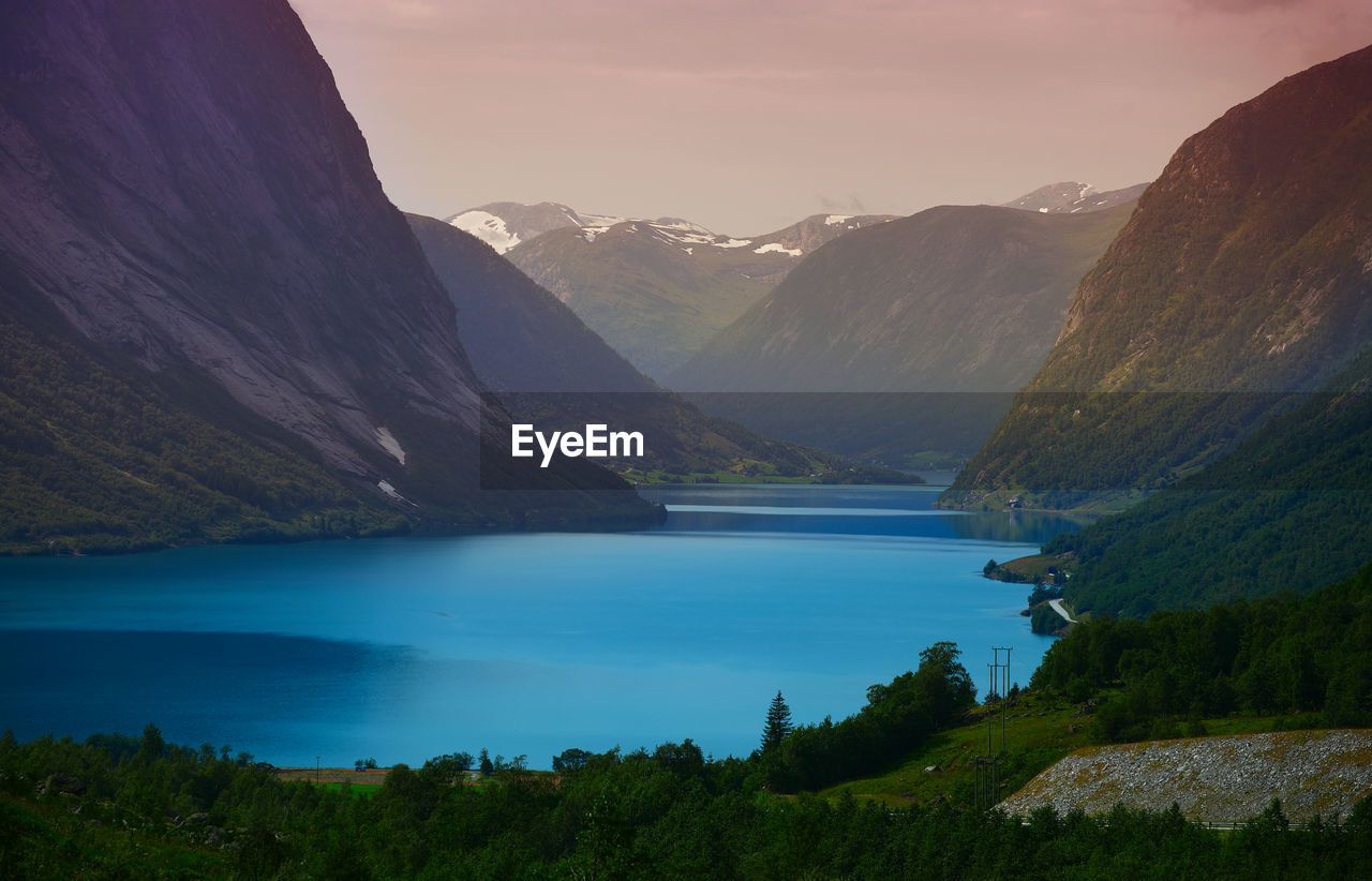 Scenic view of lake and mountains against sky