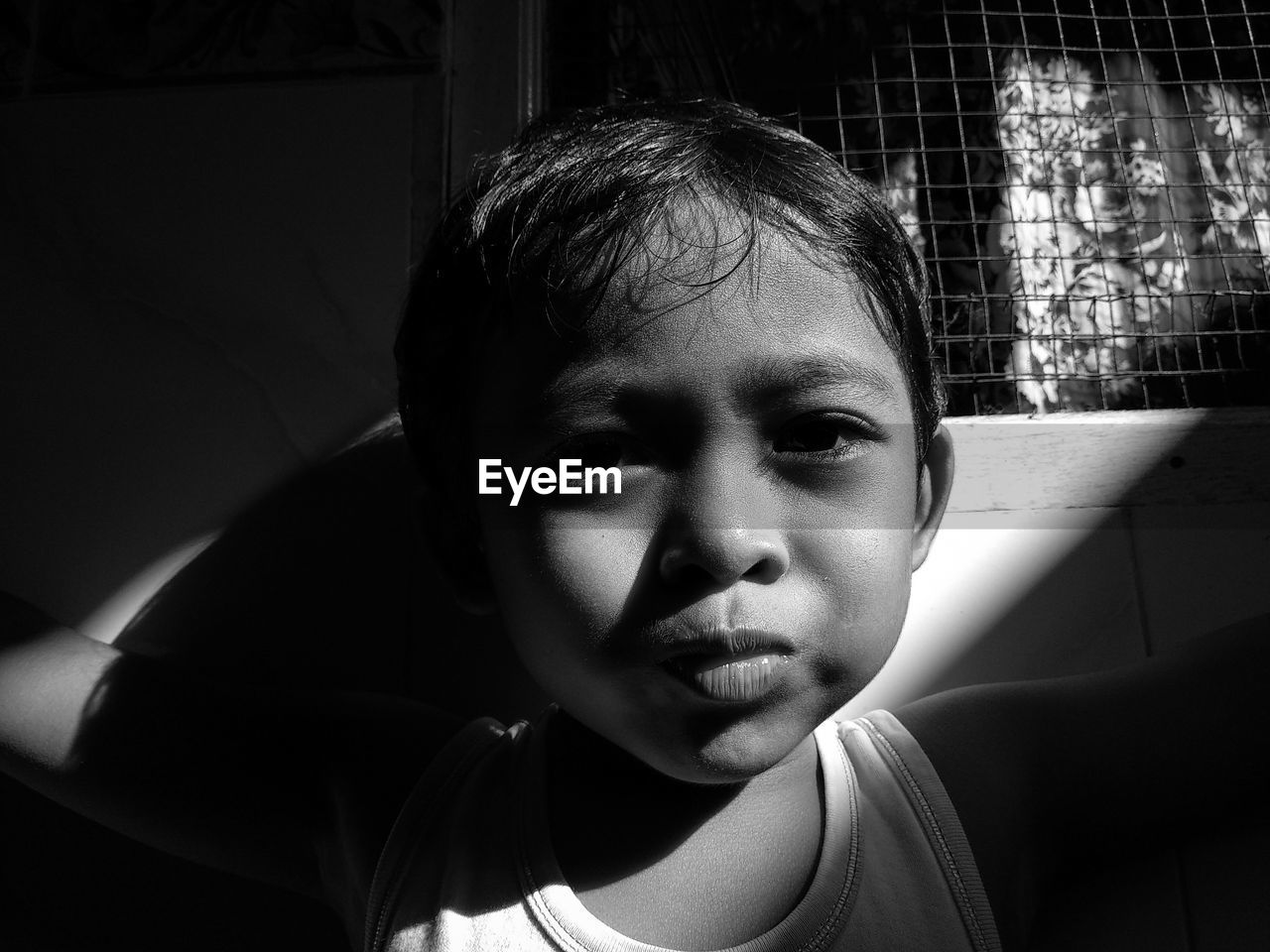 CLOSE-UP PORTRAIT OF A BOY AT HOME