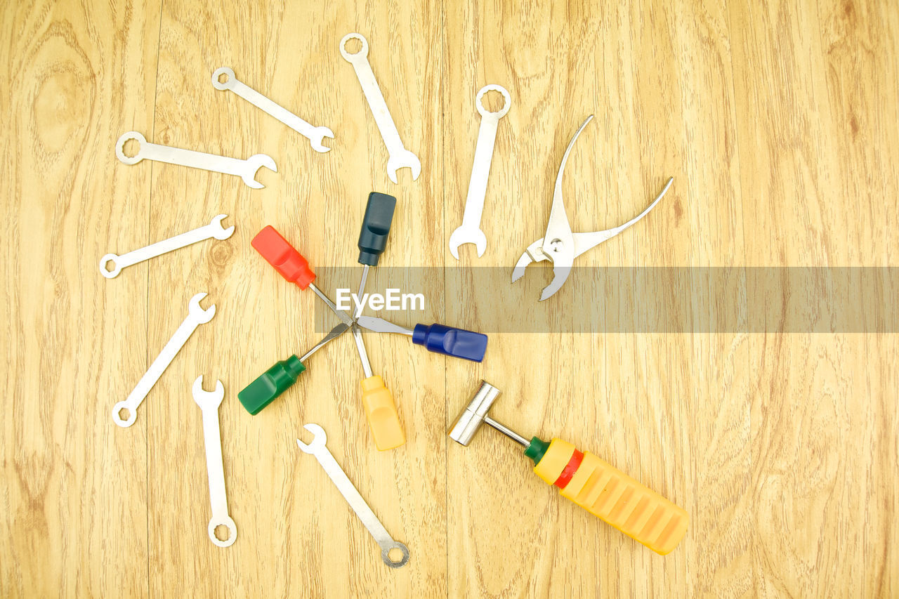 High angle view of various work tools on wooden table