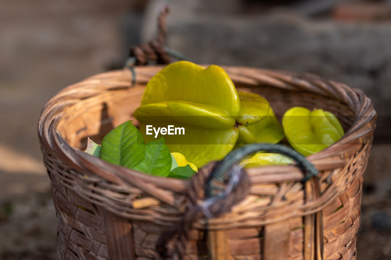 basket, container, food, food and drink, wicker, healthy eating, fruit, freshness, no people, produce, gift basket, yellow, nature, wellbeing, close-up, picnic basket, hamper, plant, citrus fruit, vegetable, outdoors, focus on foreground, selective focus, organic, leaf
