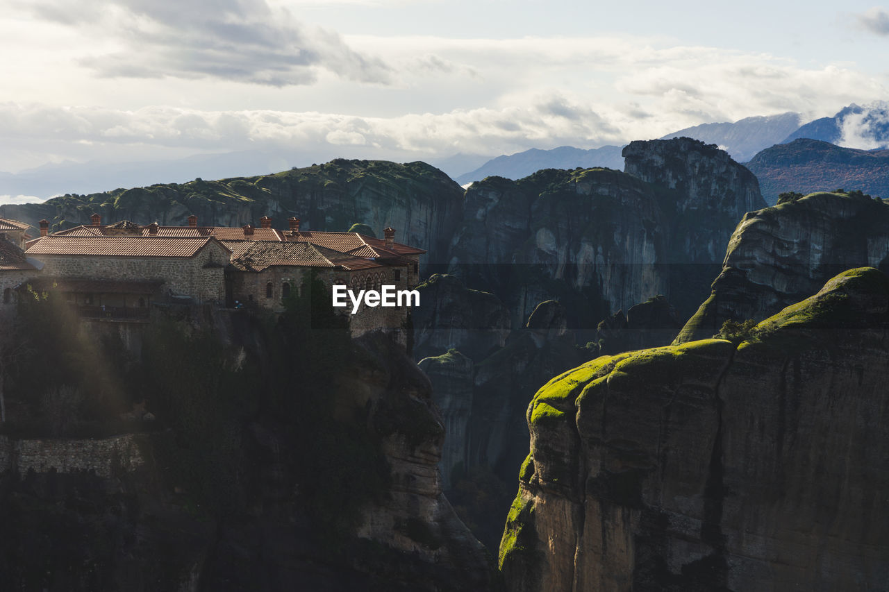 Aerial view of building on rock mountains against sky