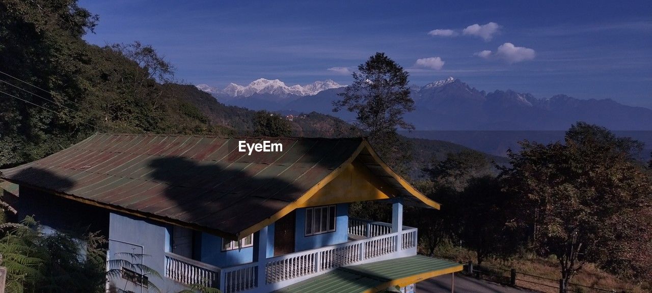 architecture, mountain, built structure, building, building exterior, house, mountain range, sky, landscape, nature, environment, tree, scenics - nature, plant, roof, beauty in nature, residential district, travel destinations, land, no people, cloud, travel, outdoors, rural scene, village, hut, tourism, valley