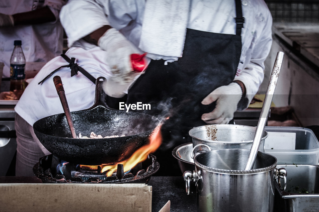 Midsection of chef preparing food in kitchen