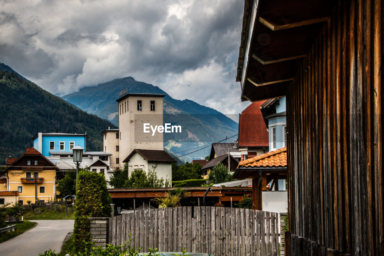 Houses and buildings in town against sky