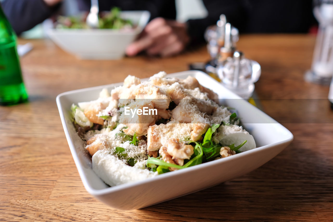 Close-up of cheese chicken salad in bowl on table