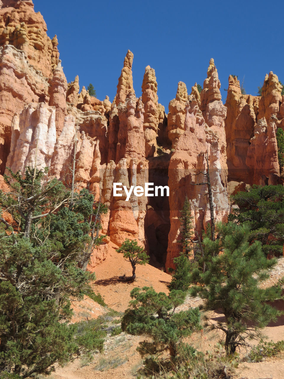 LOW ANGLE VIEW OF ROCK FORMATION AGAINST CLEAR SKY