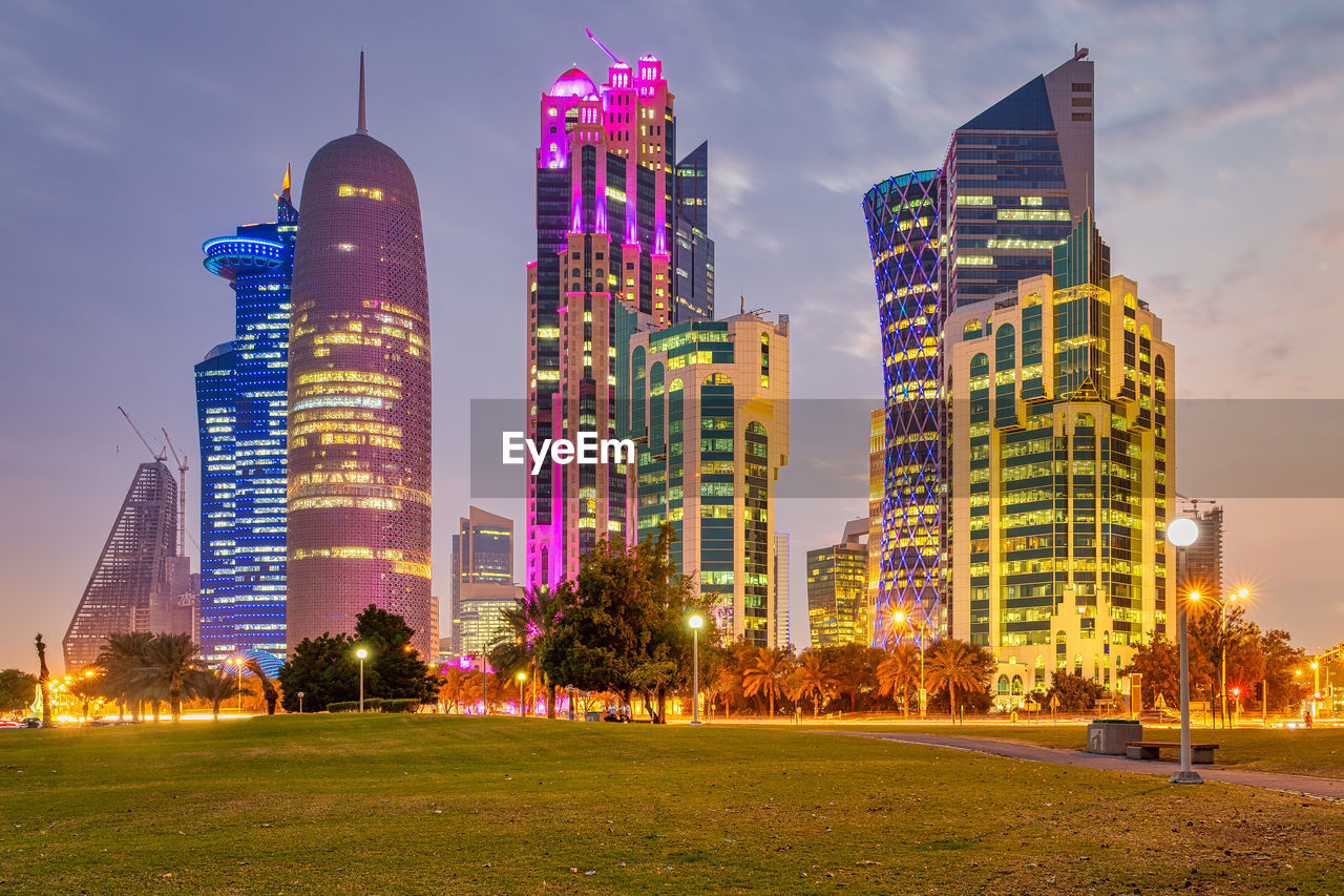 ILLUMINATED BUILDINGS AGAINST SKY AT NIGHT