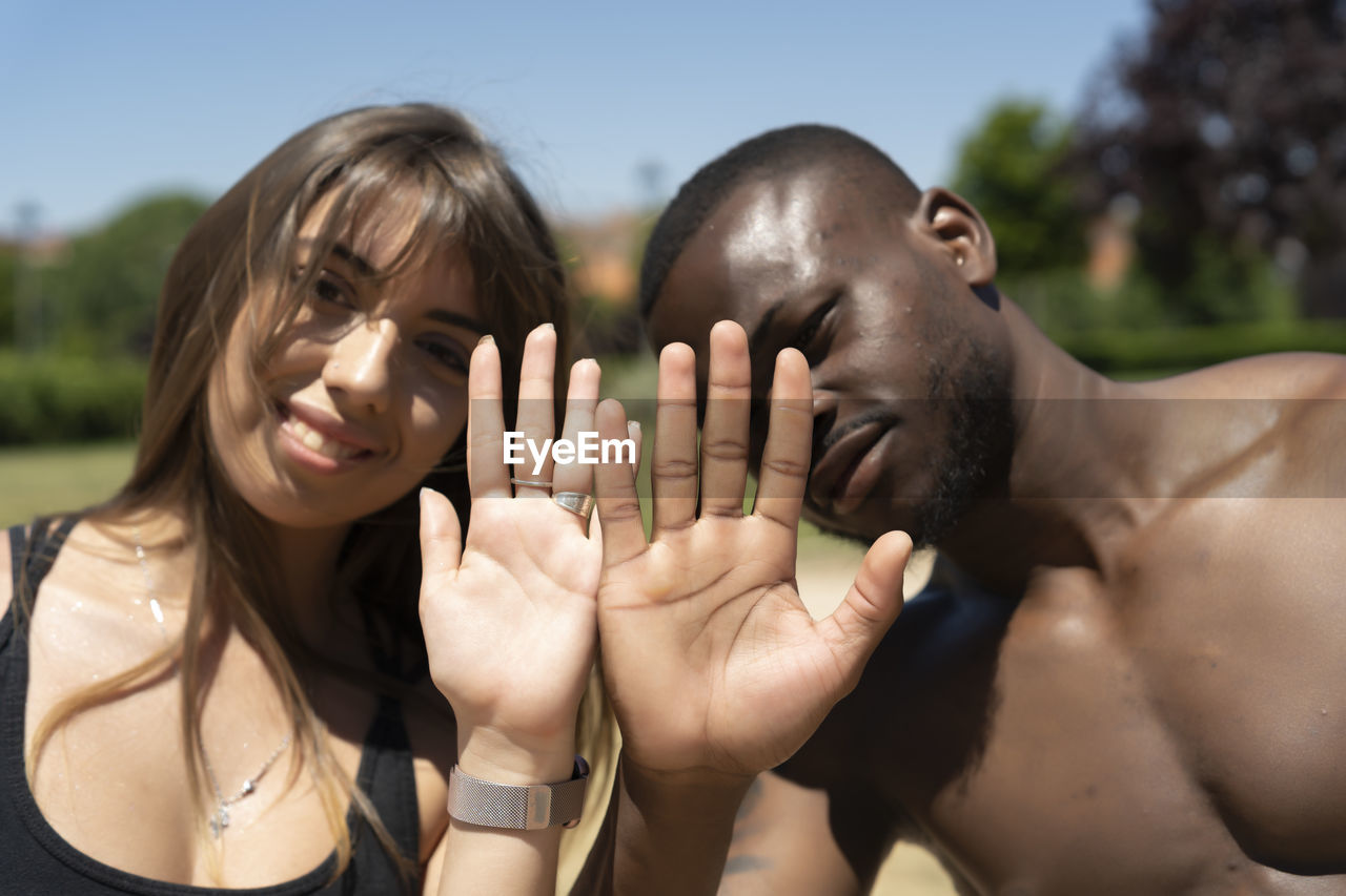 Black man and white woman holding hands