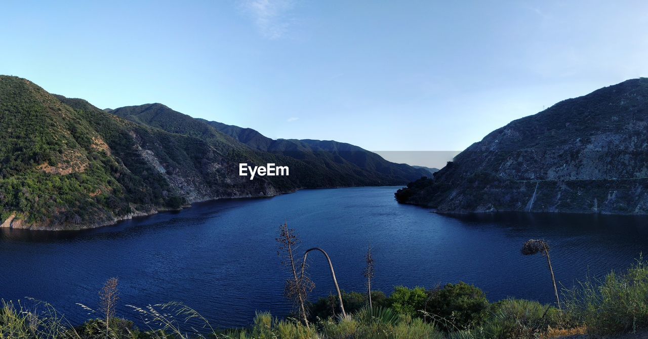 Scenic view of mountains against clear blue sky