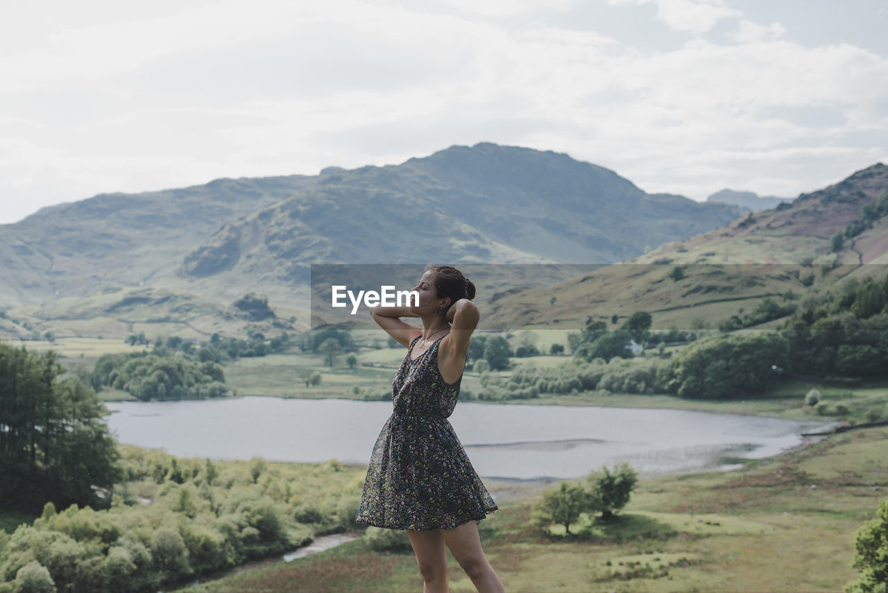 Woman standing against mountain