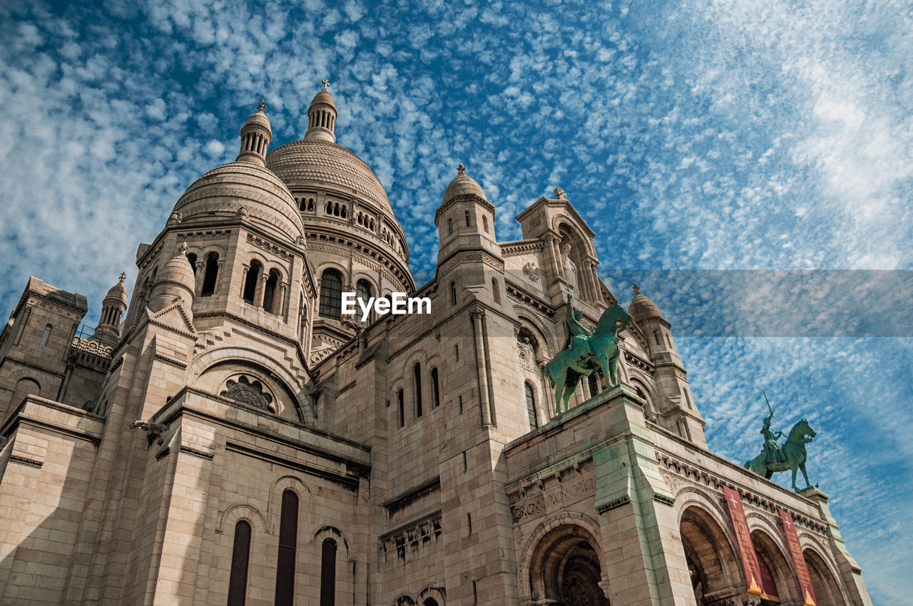 Basilica of sacre coeur facade and cloudy blue sky in paris. the famous capital of france.